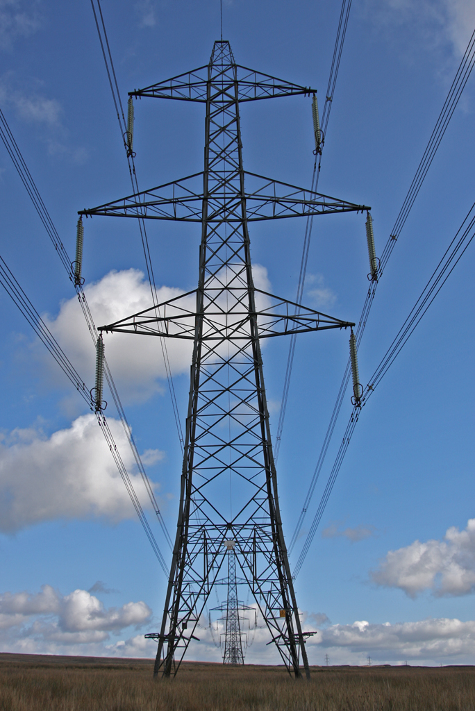 Line of electric pylons stretching into the distance on the moors above Ebbw Vale