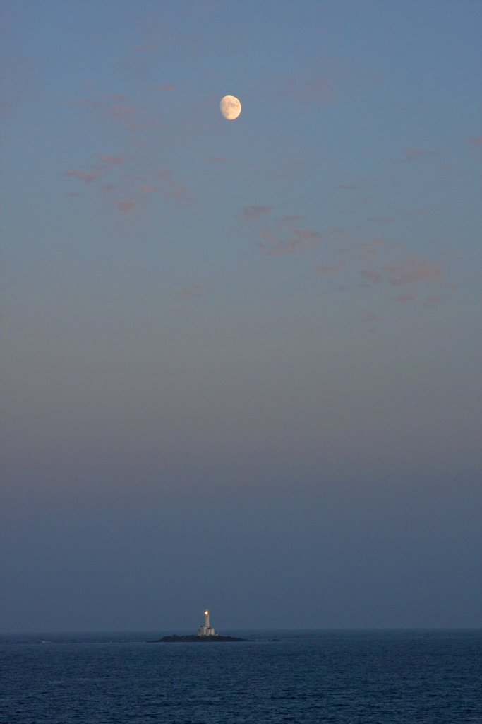 Sailing Home, with The Moon and a Lighthouse behind us