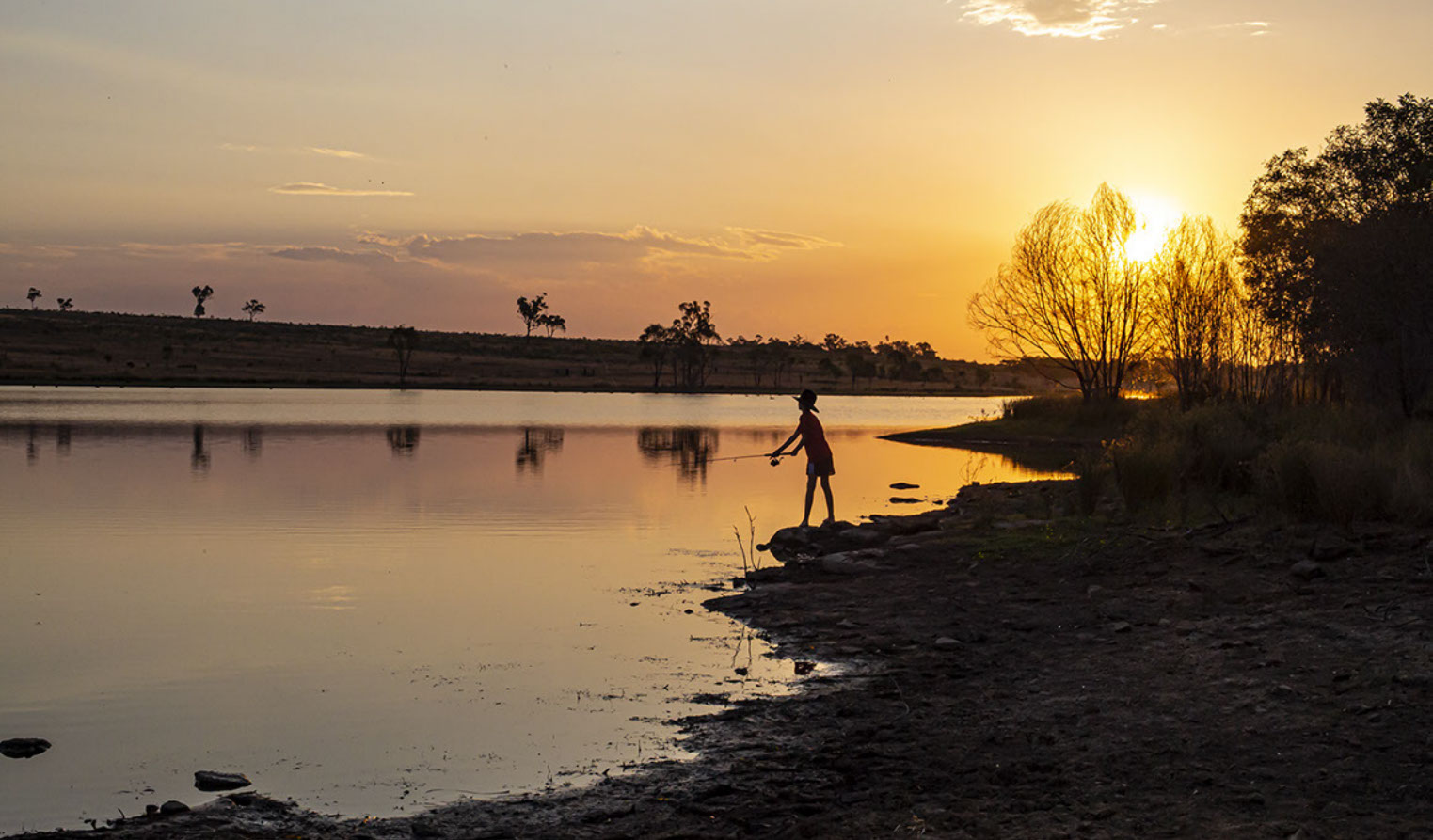 Boy fishing in "Dam" (Artificial lake) in Queensland, Australia.
